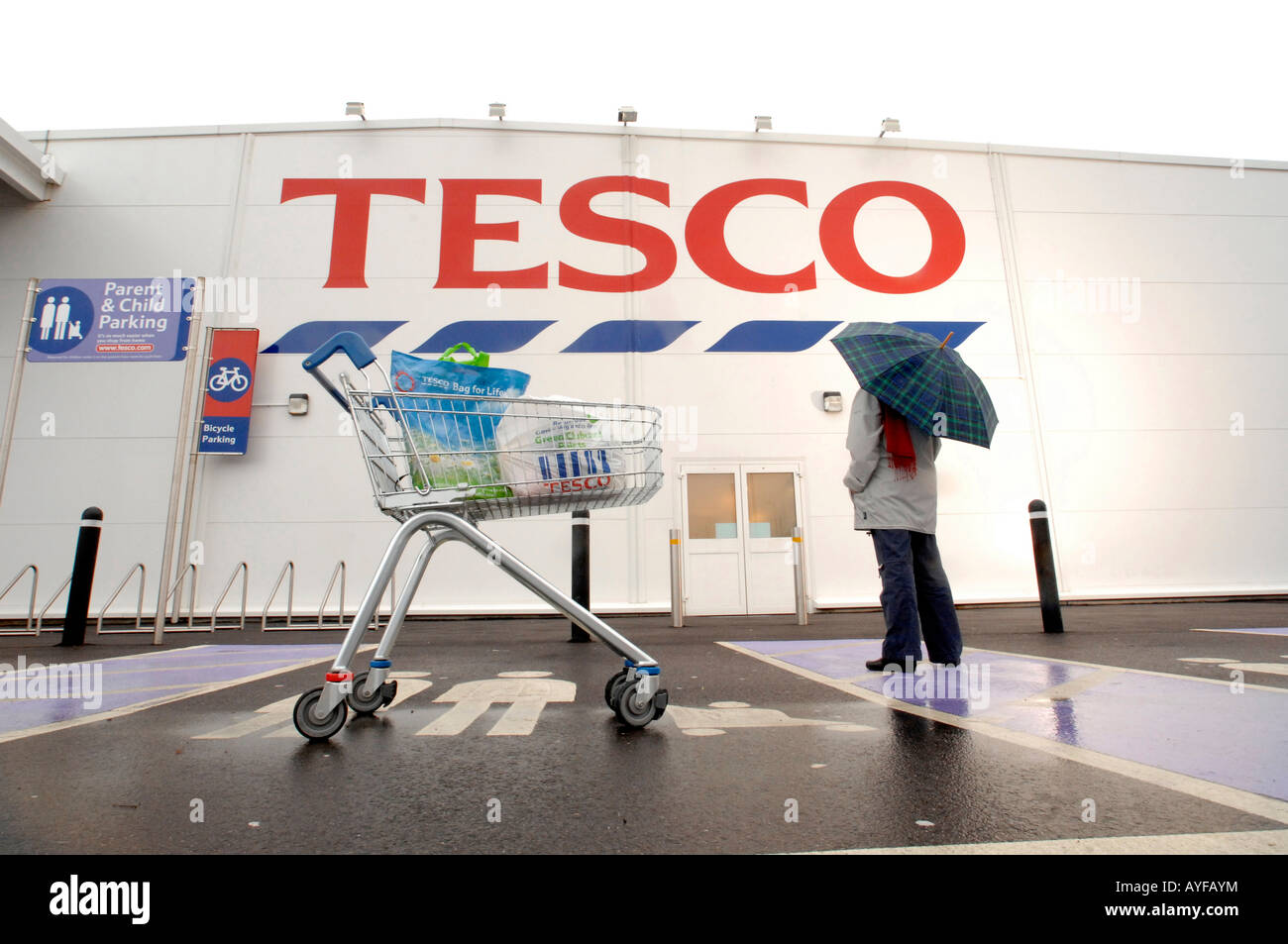 a shopper at the Tesco store Devon with trolley Stock Photo