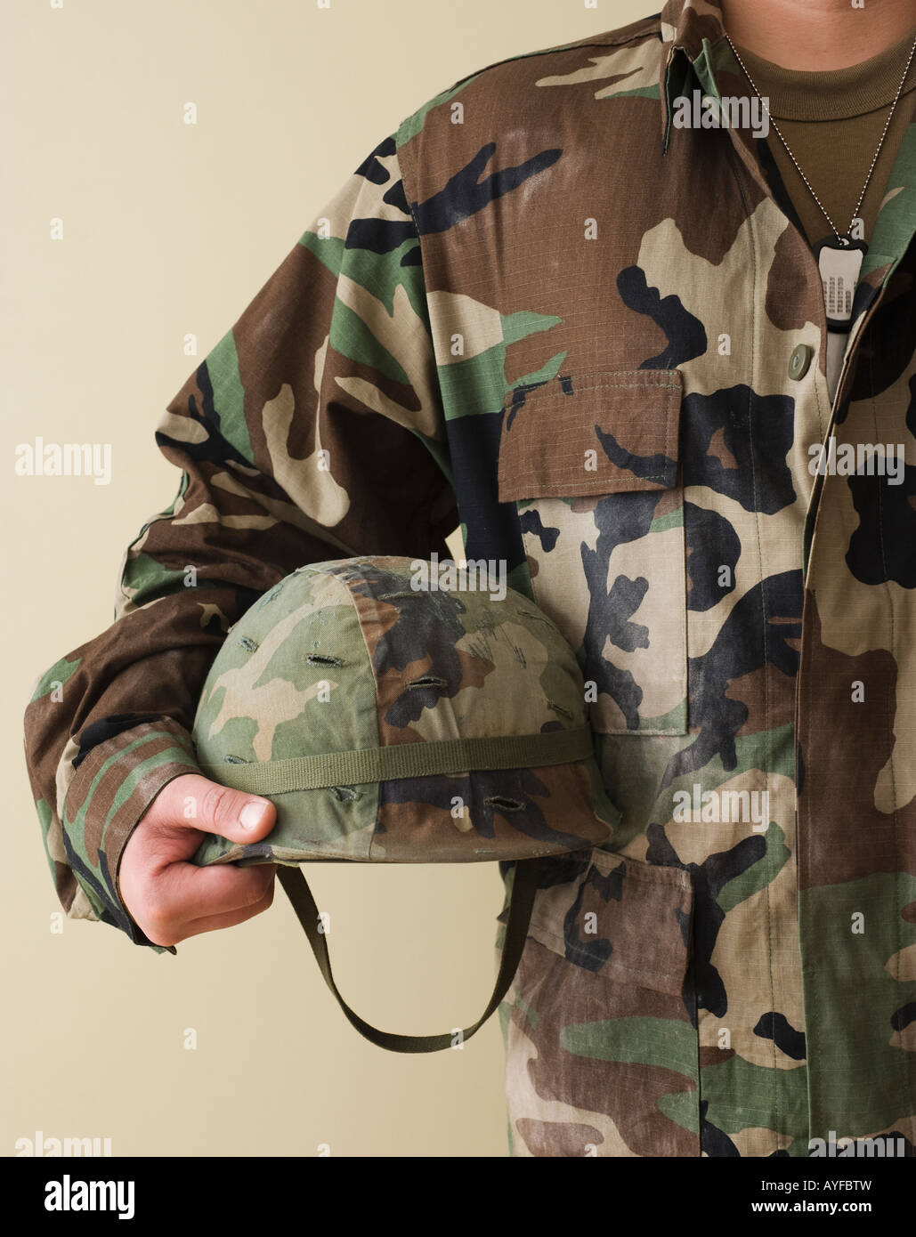 Male soldier holding helmet Stock Photo