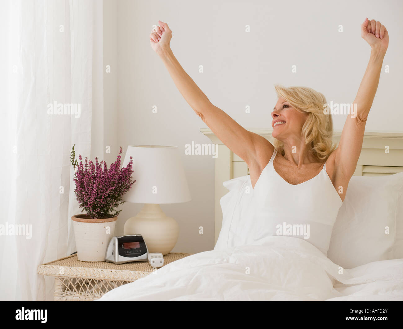 Woman stretching in bed Stock Photo