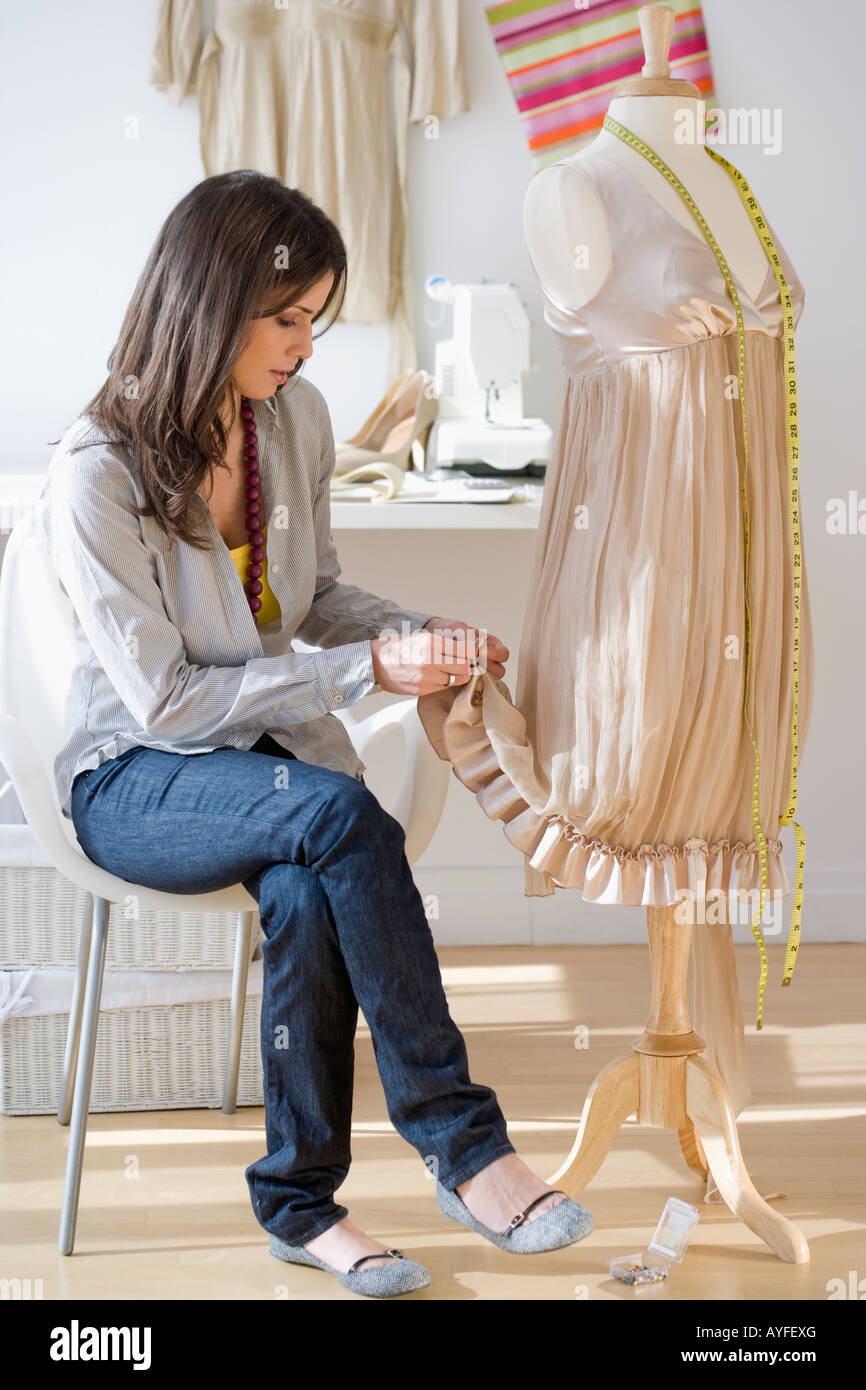 Seamstress hemming dress Stock Photo Alamy