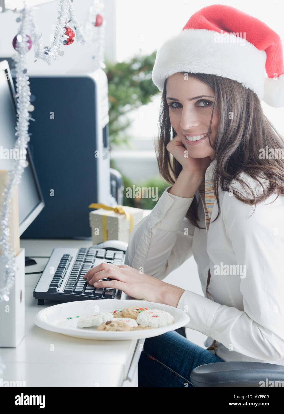 Businesswoman wearing Santa Claus hat Stock Photo - Alamy
