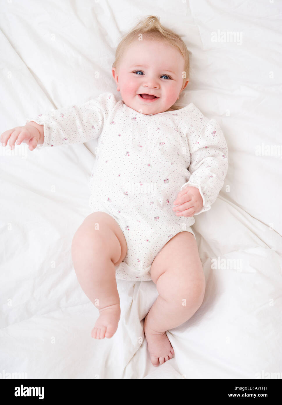 Baby laying on bed Stock Photo Alamy