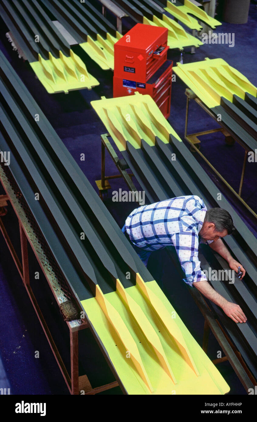 Inspector using micrometer to check airfoil sections Stock Photo