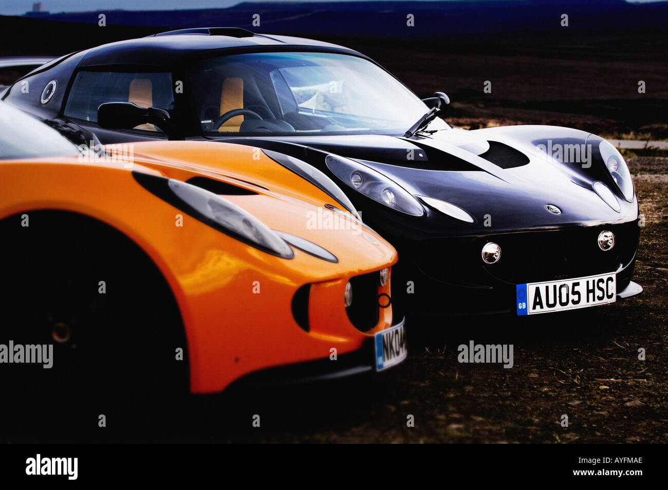 Side and front view of 2 Lotus Exige cars parked side by side on the North Yorkshire Moors. UK. Stock Photo