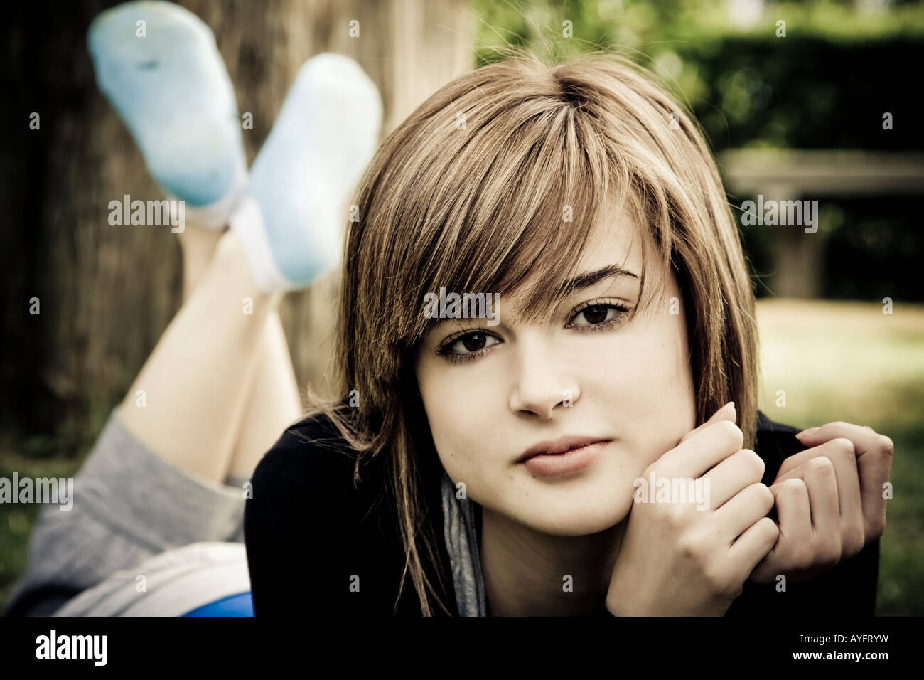 Beautiful young woman resting in the park Stock Photo - Alamy