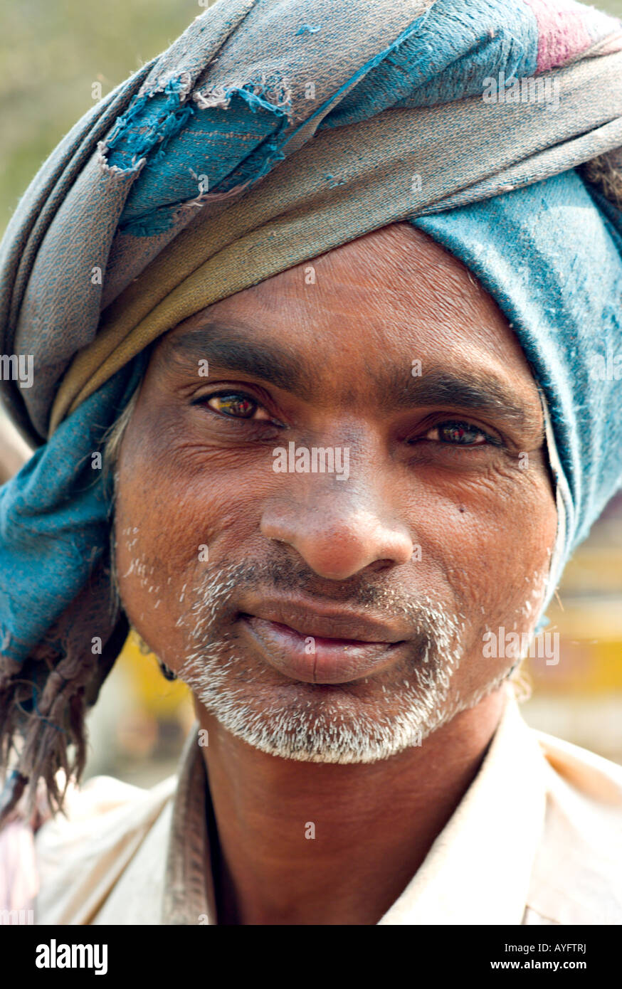 INDIA NEW DELHI Portrait of homeless man wearing a tattered blue turban and living on the streets of New Delhi Stock Photo