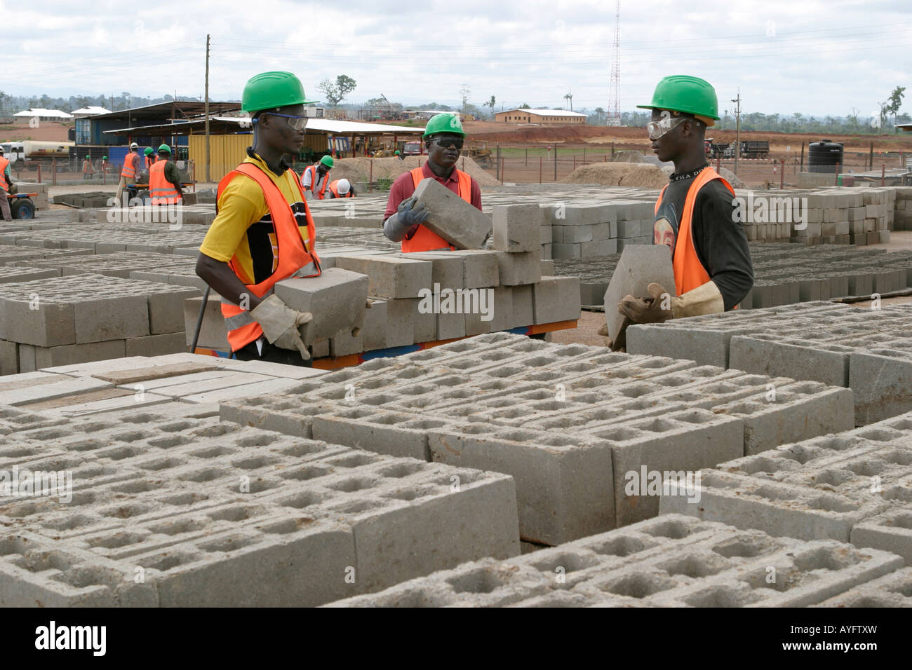 Local labour workers making breize blocks for building site and
