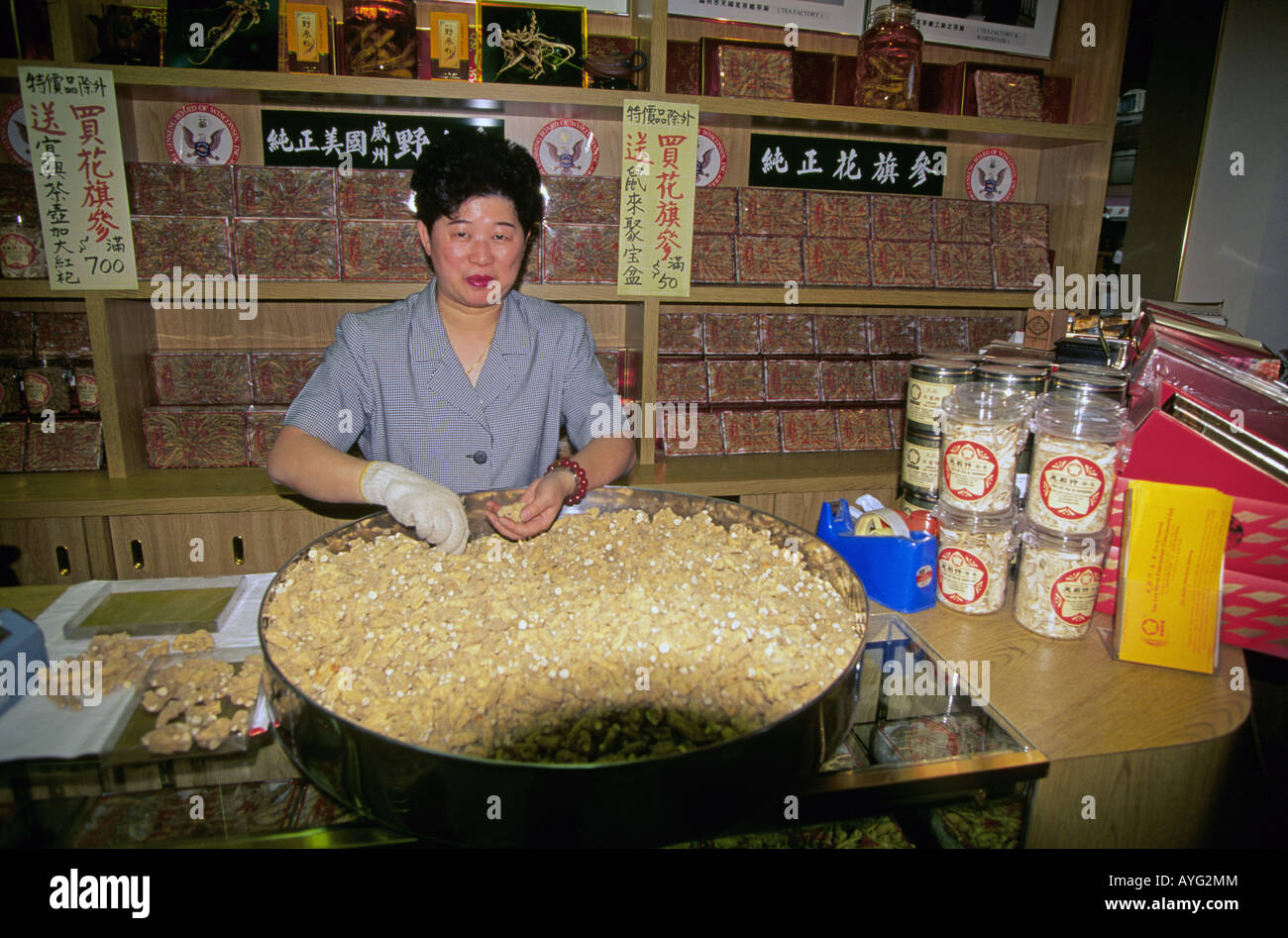 A chinese woman makes candy in a small store in China town in Vancouver Canada Stock Photo
