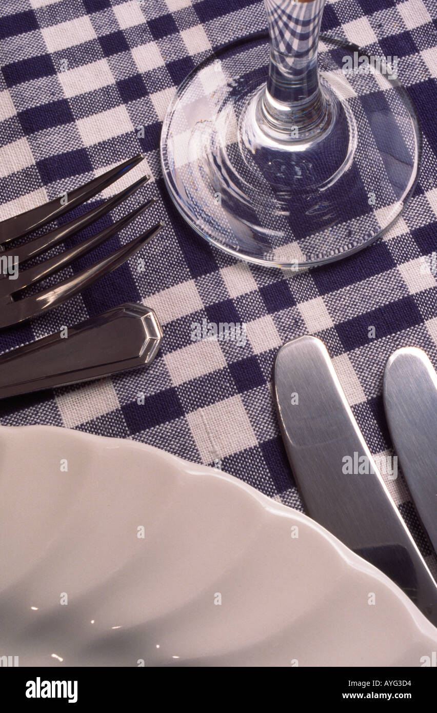Dining table place setting on blue and white cloth Stock Photo