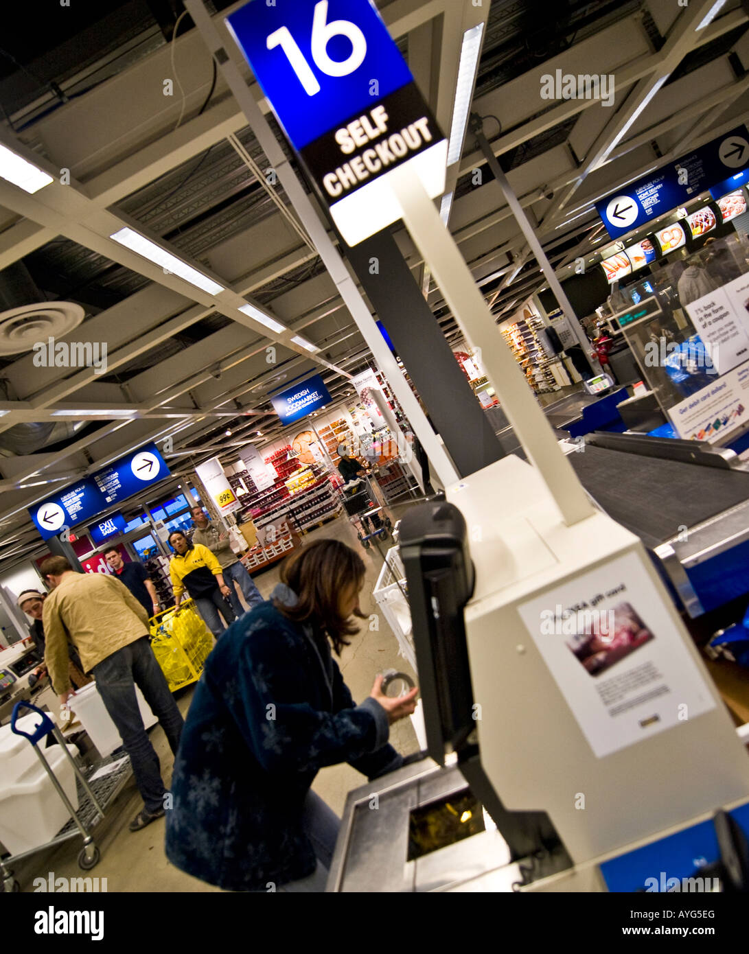Woman purchasing items at a self checkout station at an Ikea store