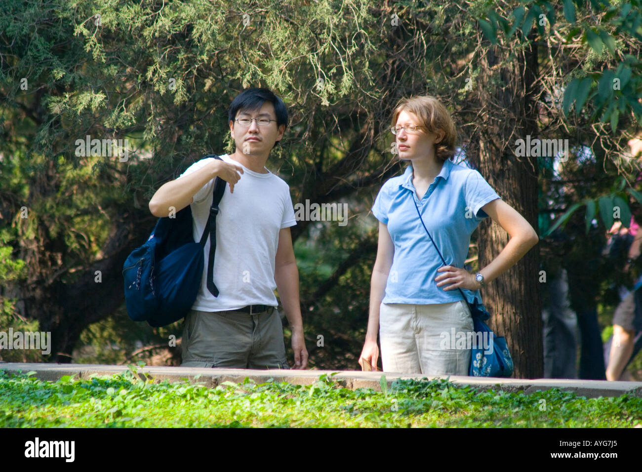 Korean American and Caucasian American Woman standing together in a park Stock Photo