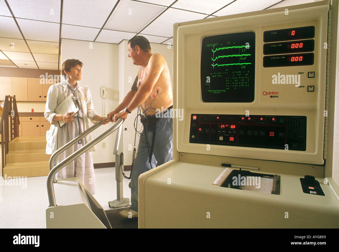 Treadmill test registered nurse monitors cardiac patient Stock Photo