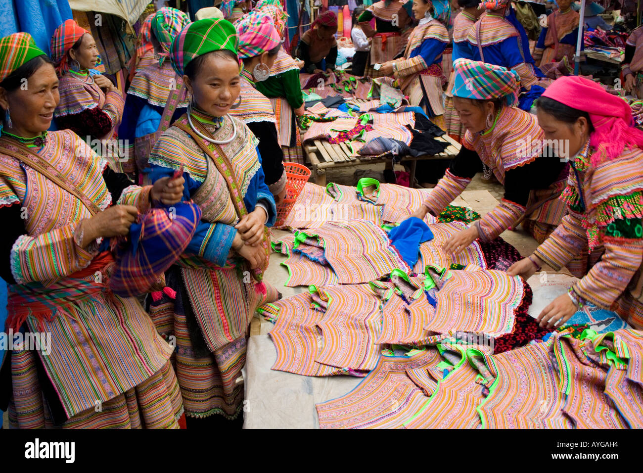 Flower Hmong Women Buy and Sell Colouful Clothing and Fabrics Bac Ha Market near Sapa Vietnam Stock Photo