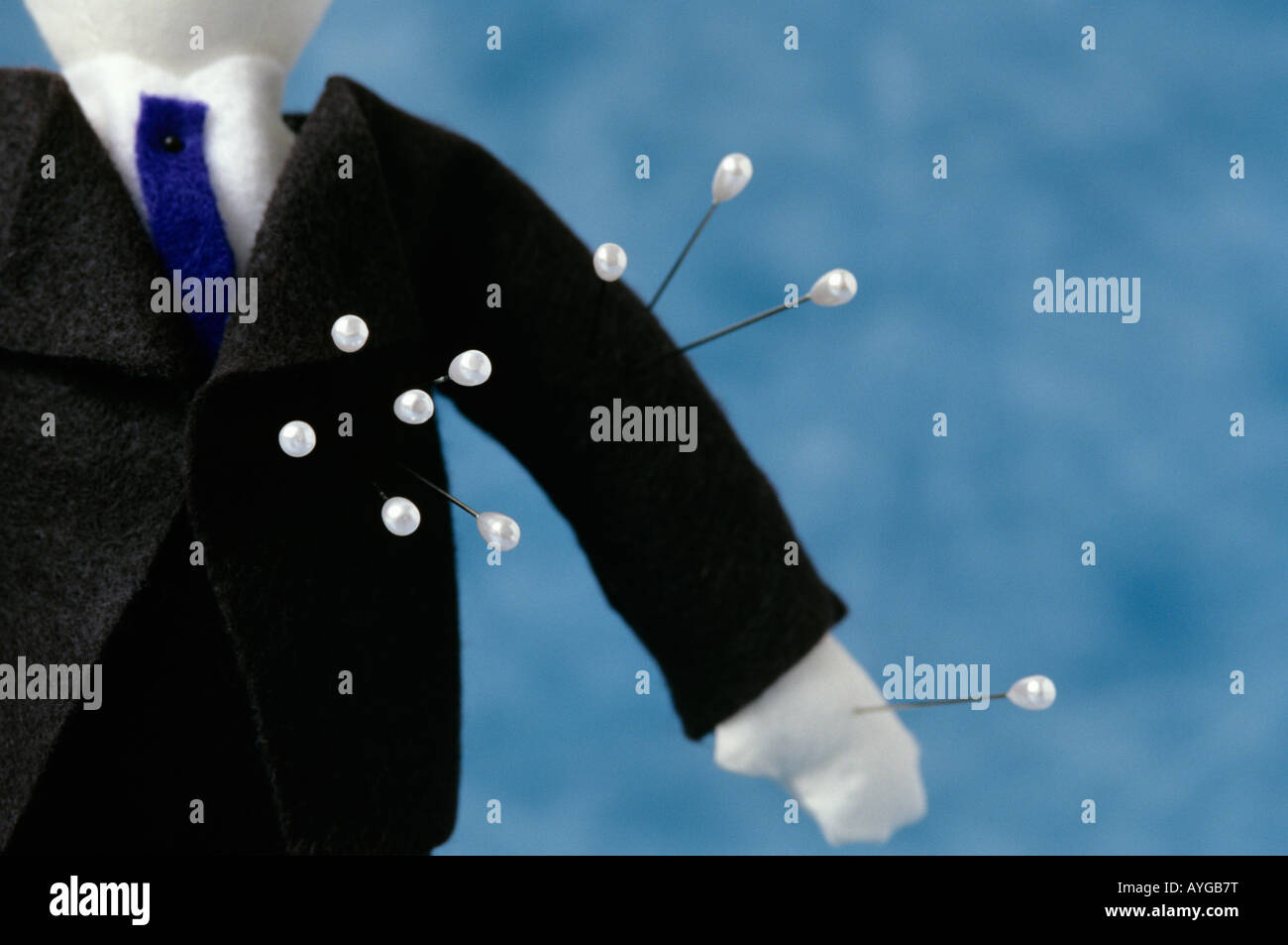 Voodoo doll standing in an office dressed as a business man in a black