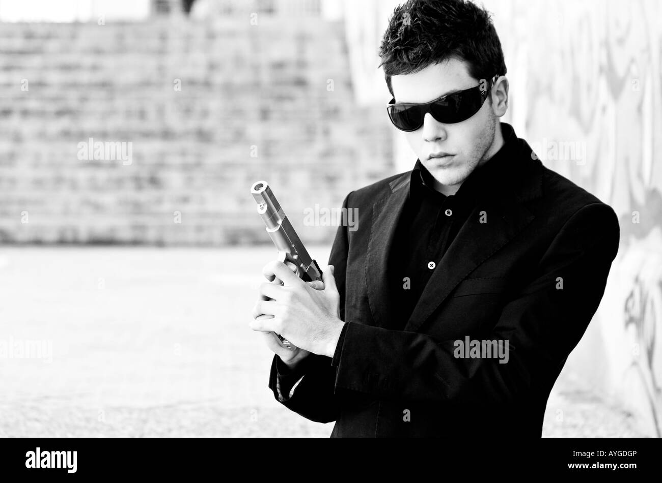 Male model performing secret agent with gun Stock Photo