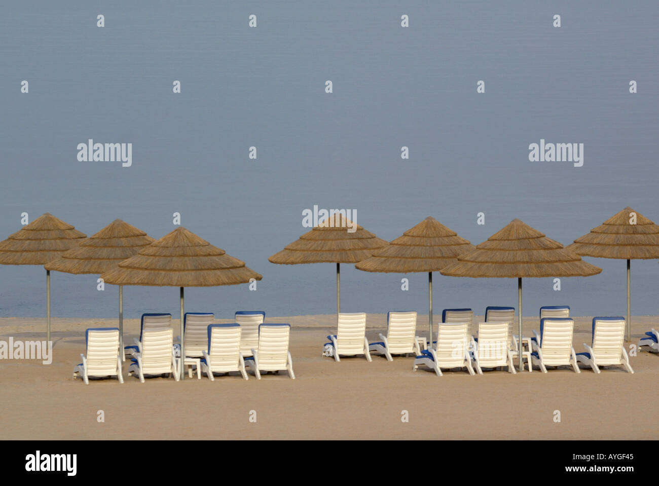 Beach Chairs And Umbrellas Set Up Along The Beach Front Of The