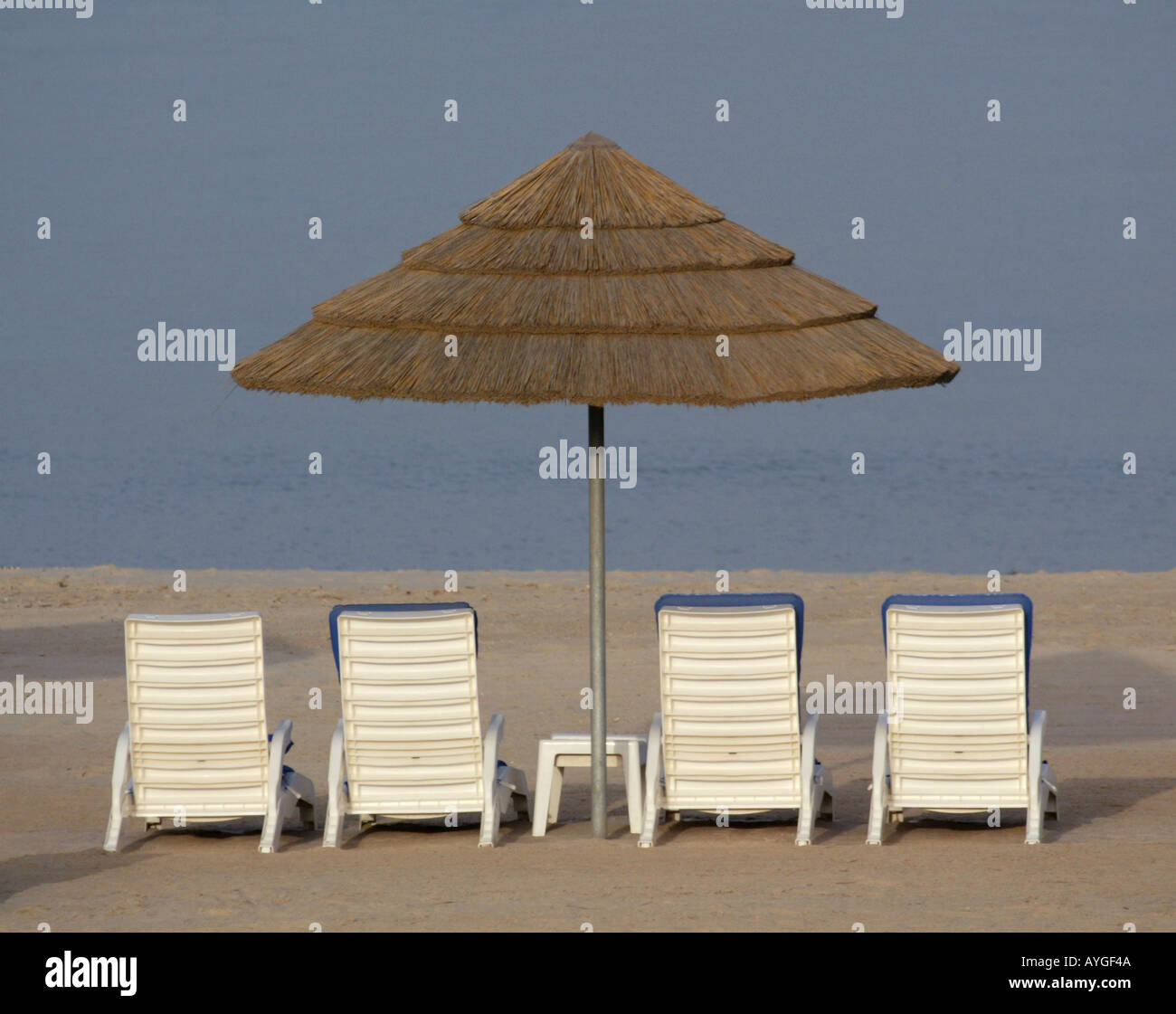 Beach Chairs And Umbrellas Set Up Along The Beach Front Of The