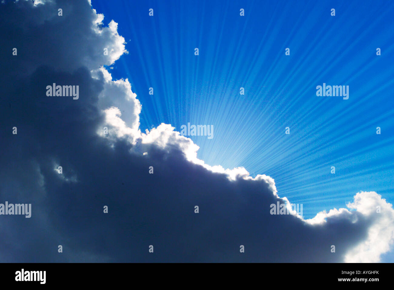 sun rays emerging from behind clouds Stock Photo - Alamy
