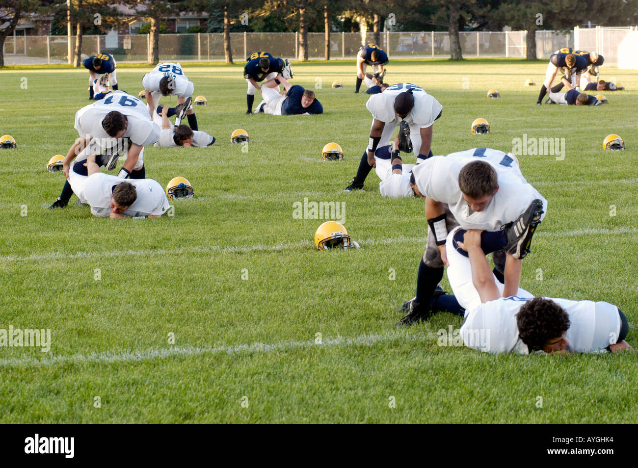 Football players warm up with exercises before playing in a game Stock