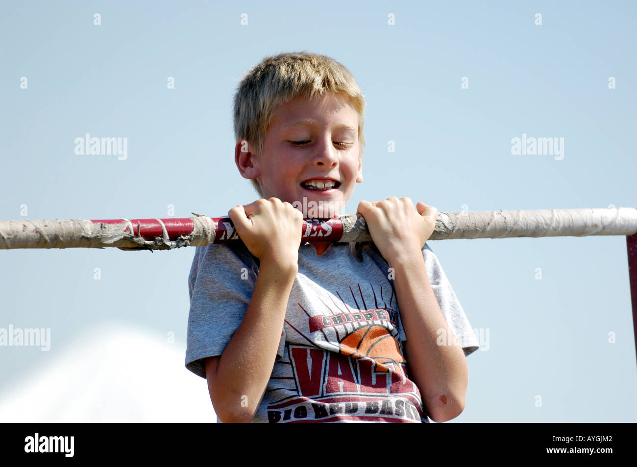 Boy doing a series of pull ups for a fitness test Stock Photo