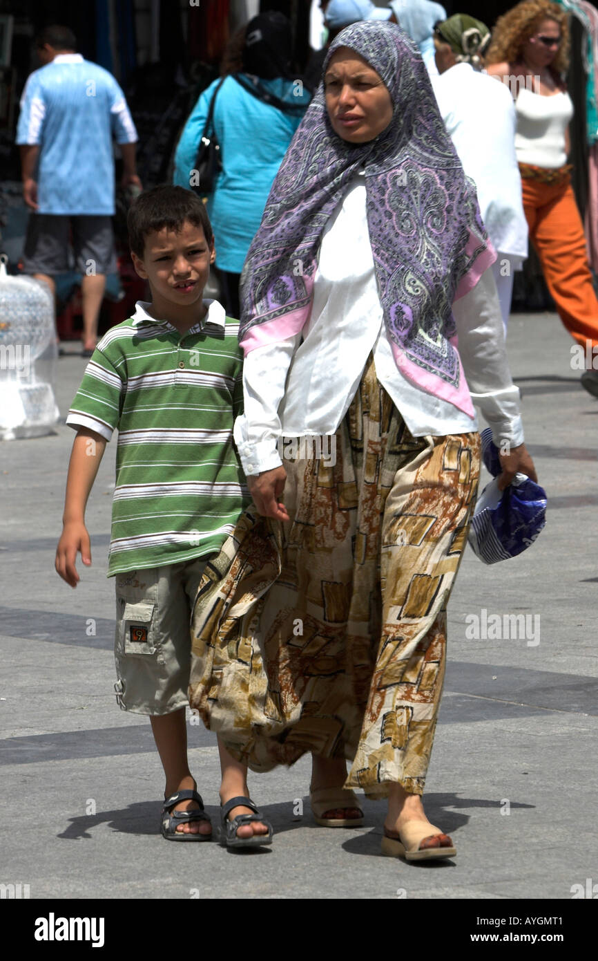Woman in traditional dress with young boy Place del la Victoire the Medina Tunis Tunisia Stock Photo