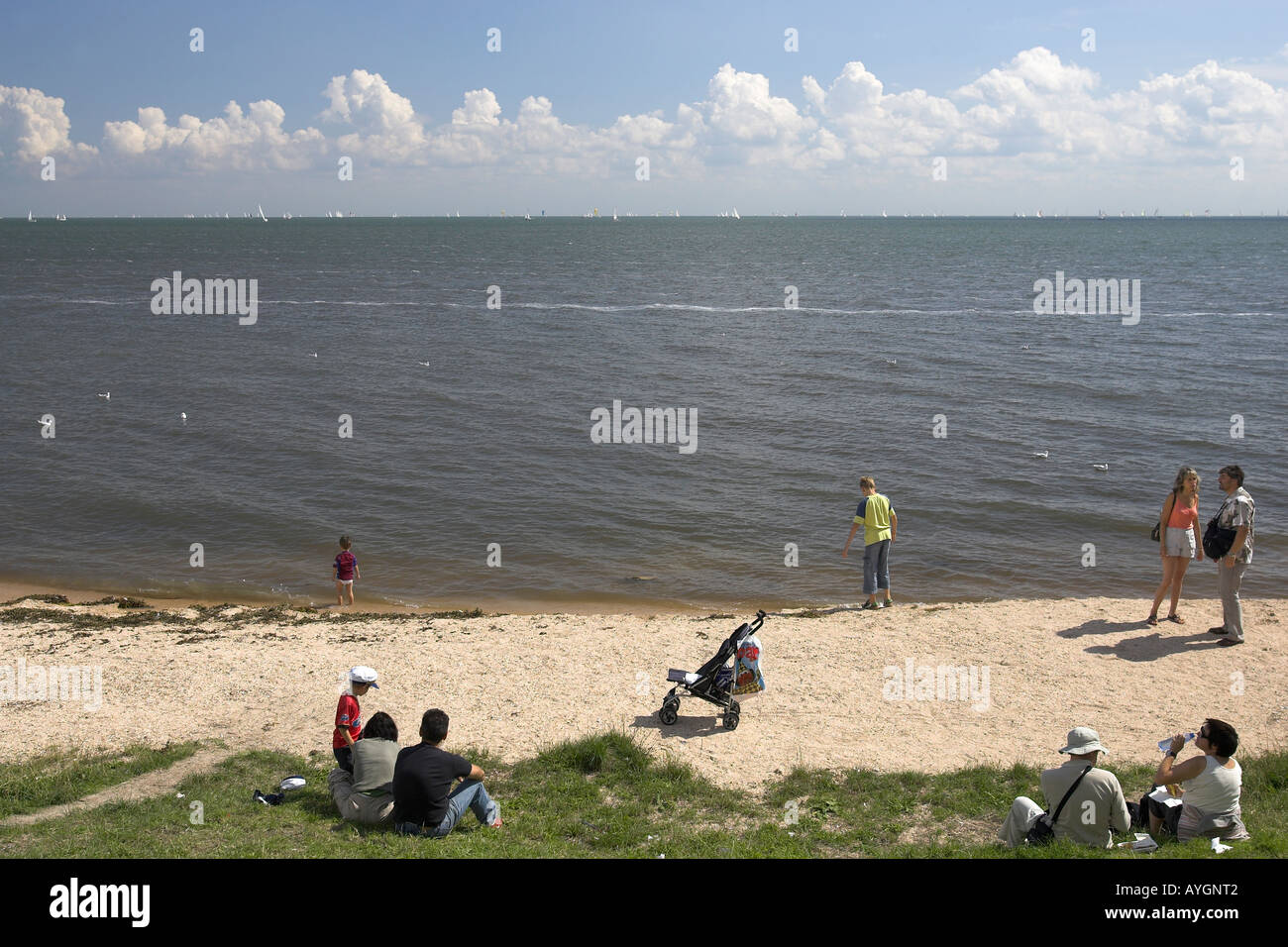 Visitors enjoy the small beach at Volendam fishing village The Netherlands Stock Photo