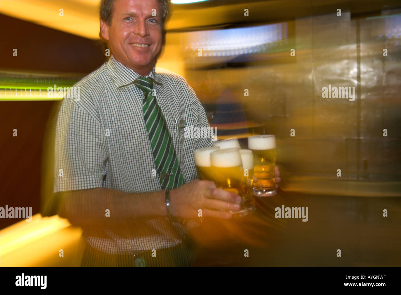 Bar host with hands full of frothing beer Heineken Experience Amsterdam