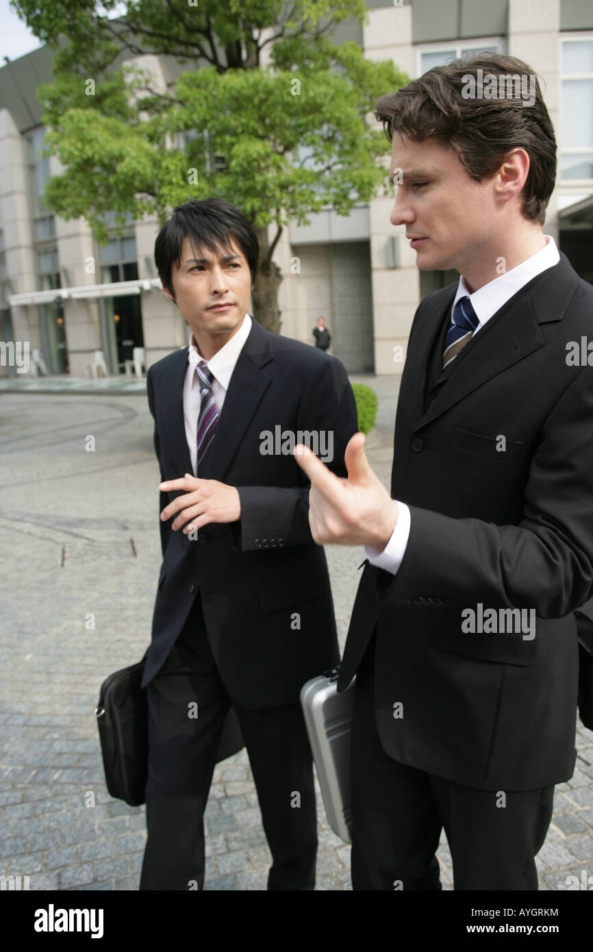 Two businessmen talking walking hi-res stock photography and images - Alamy