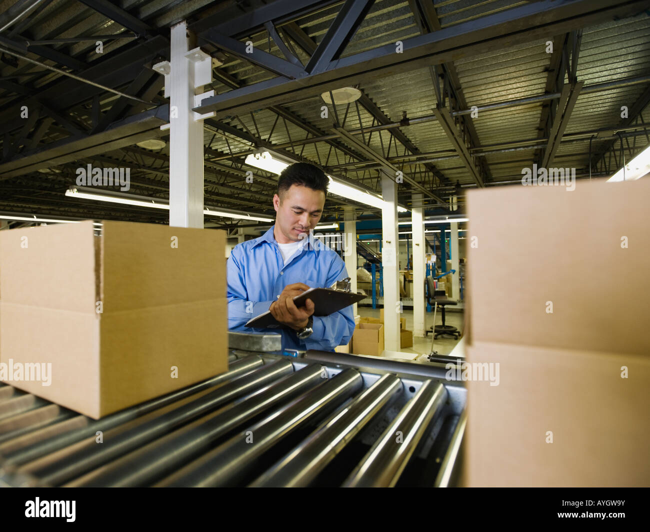 Asian male factory worker checking product Stock Photo