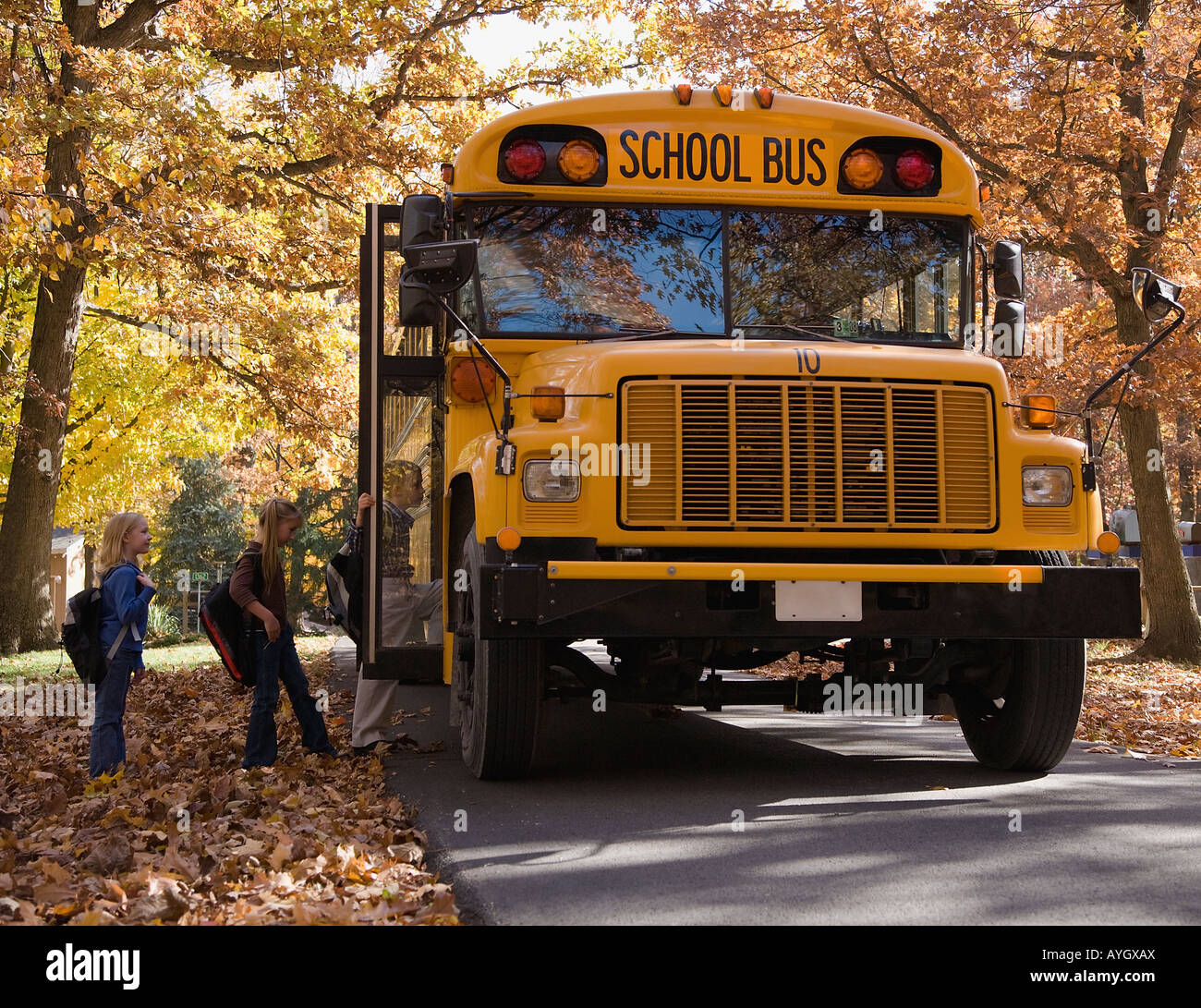 Children getting on school bus Stock Photo Alamy