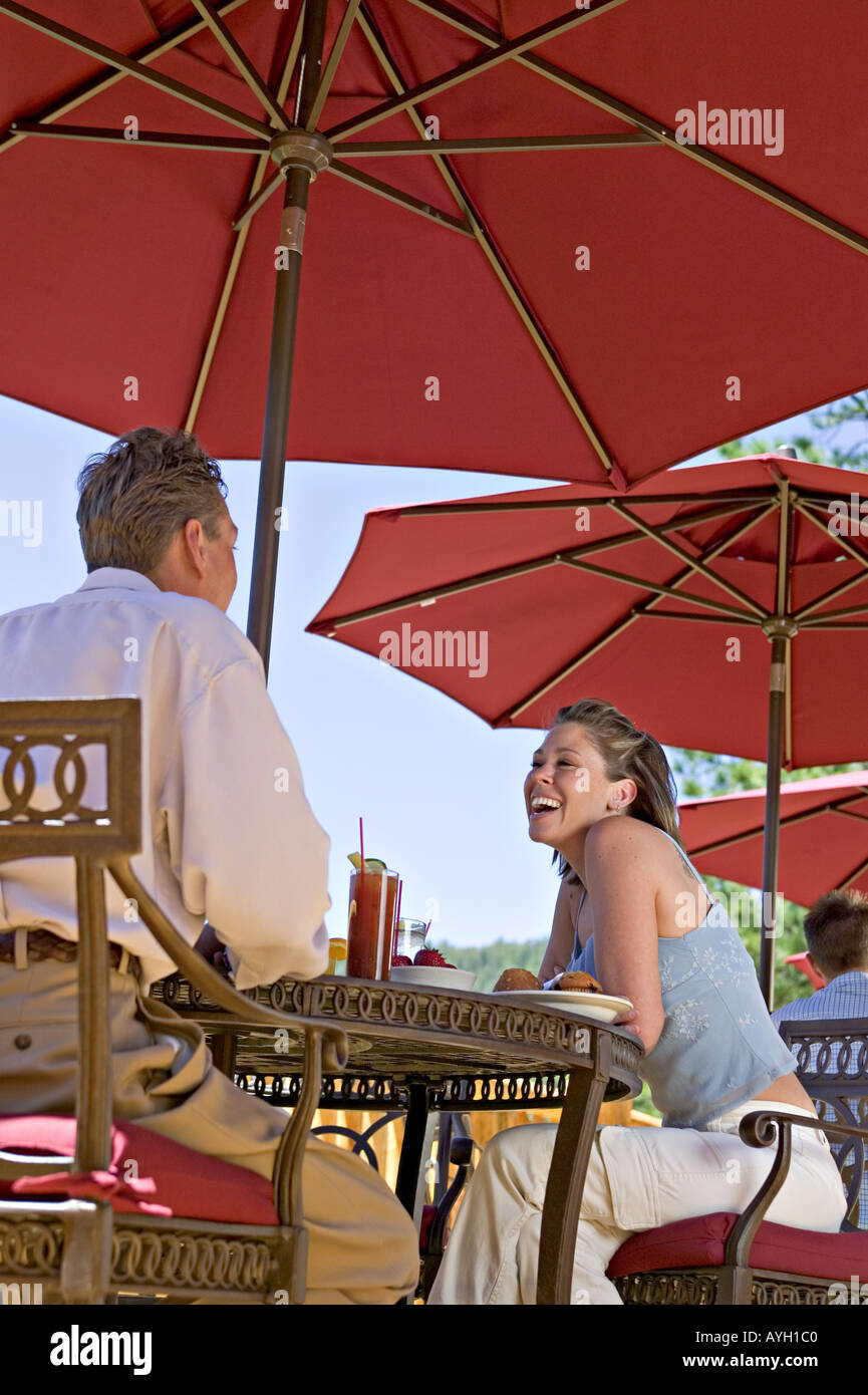 A couple enjoys a beautiful day at an outdoor cafe Stock Photo