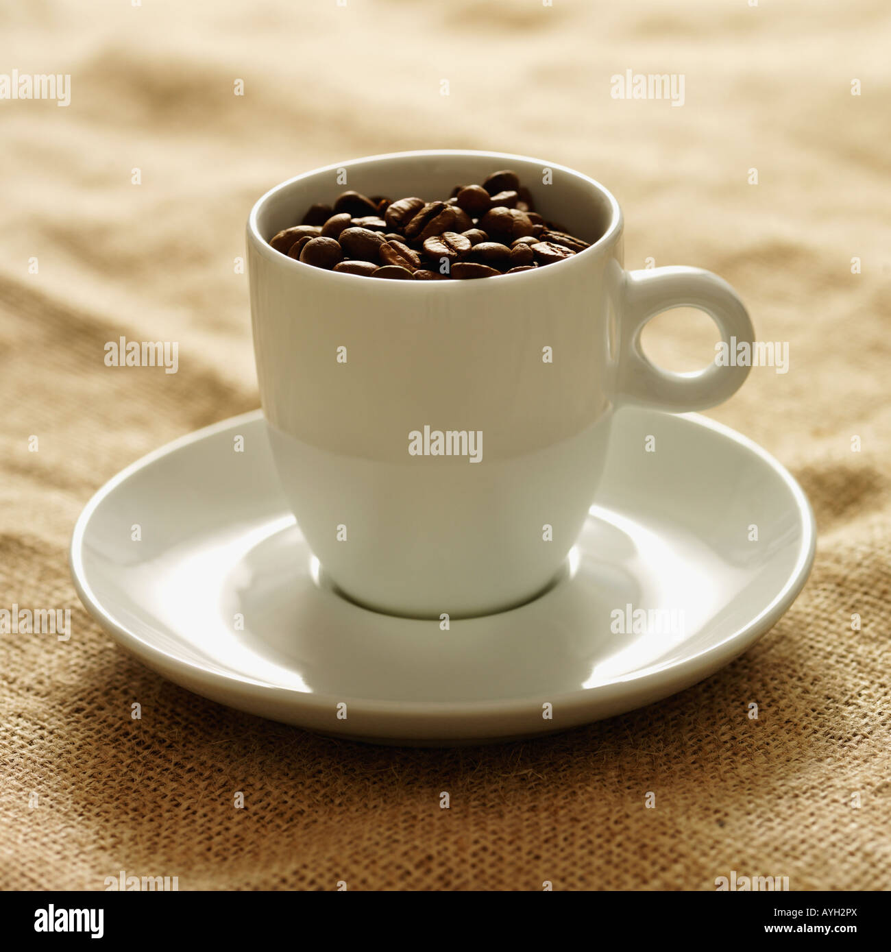 Mug filled with coffee beans Stock Photo Alamy