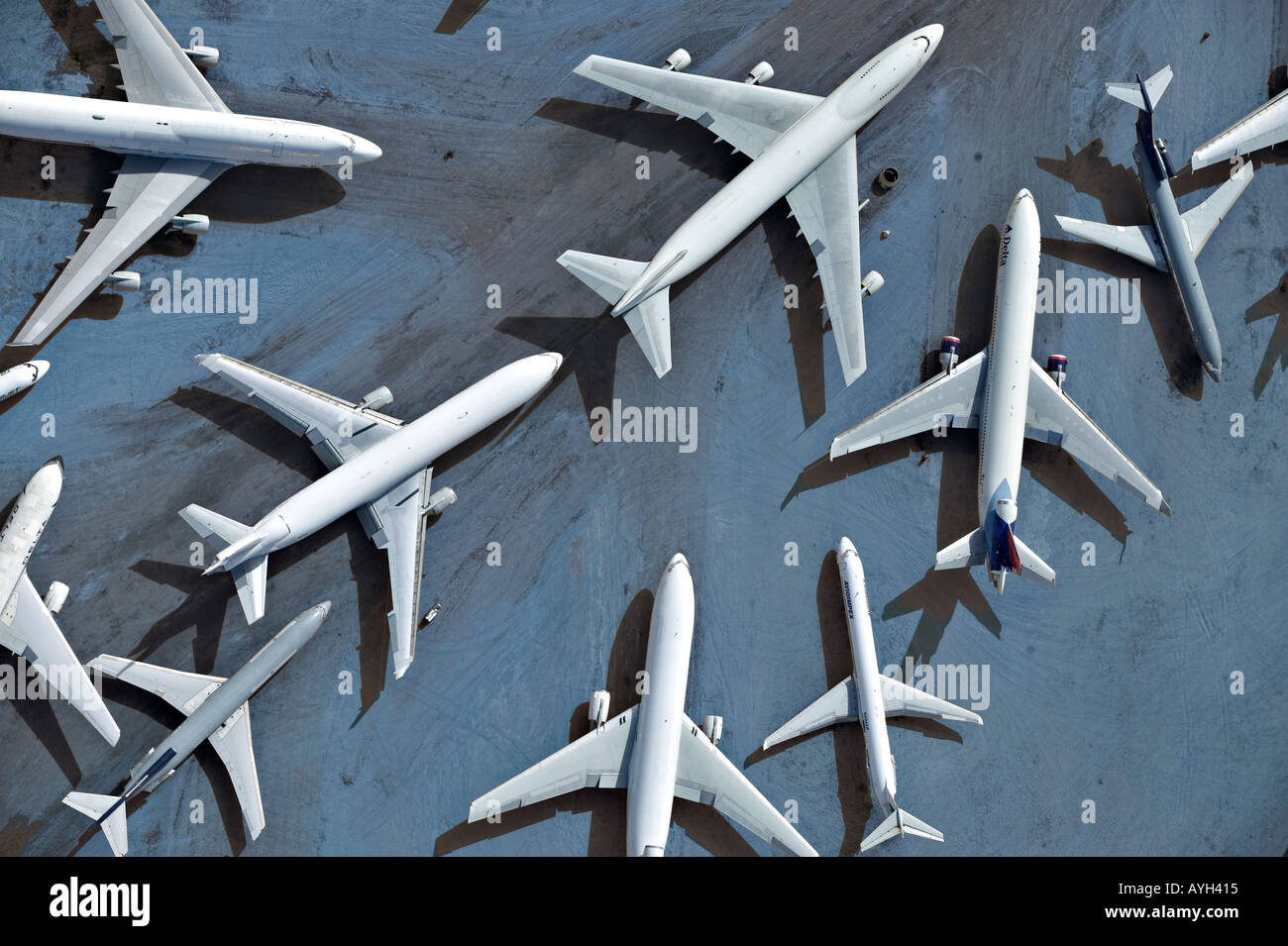 Commercial airplanes that have been taken out of commission by various international airlines are parked on an abandoned runway Stock Photo