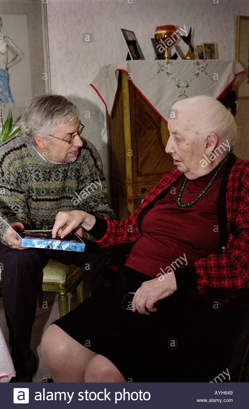 A Man And His Old Mother Eating Chocolate Of A Box Stock Photo