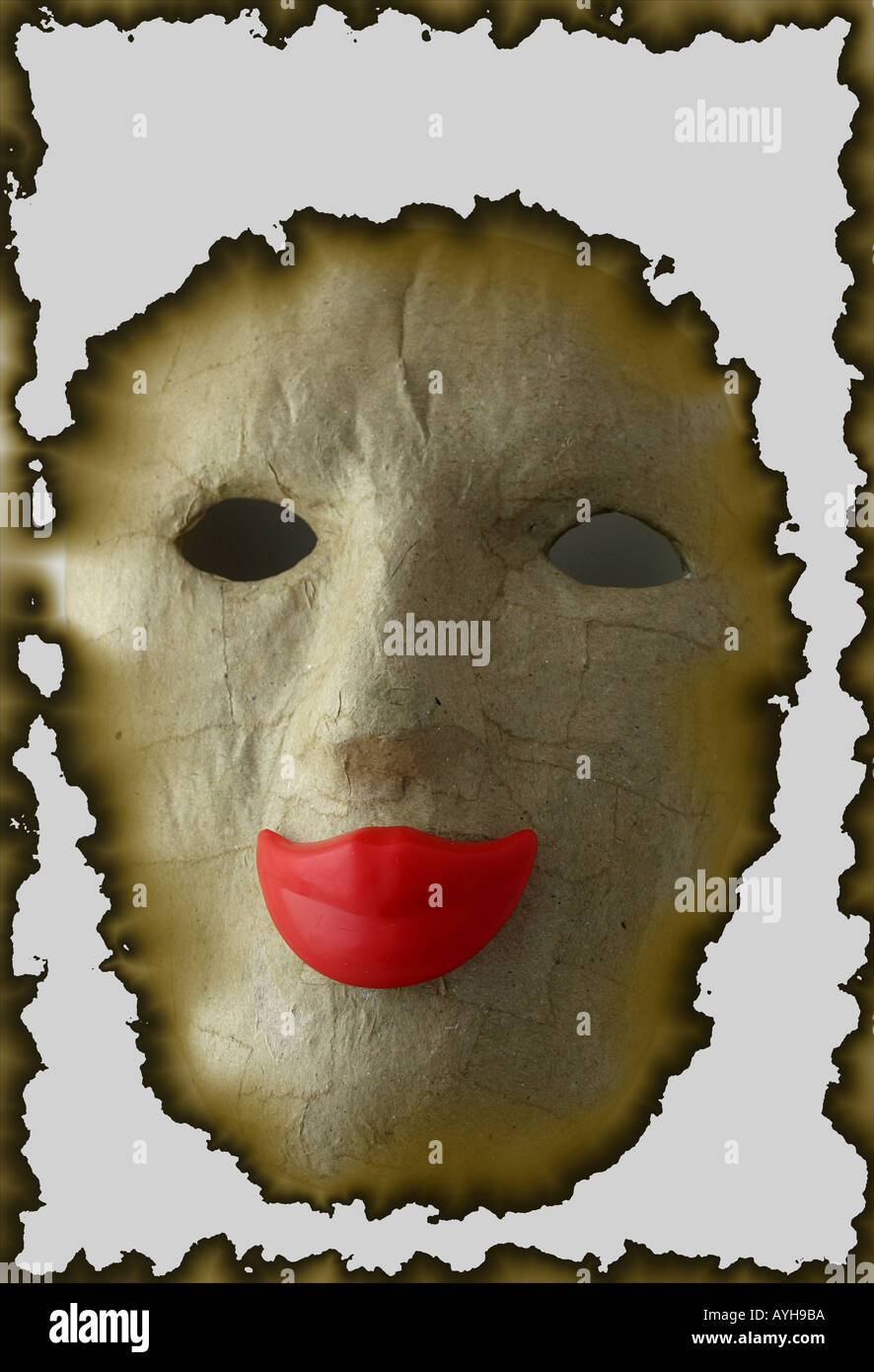 Face mask with smiling red lips and burnt out surrounding and background Stock Photo