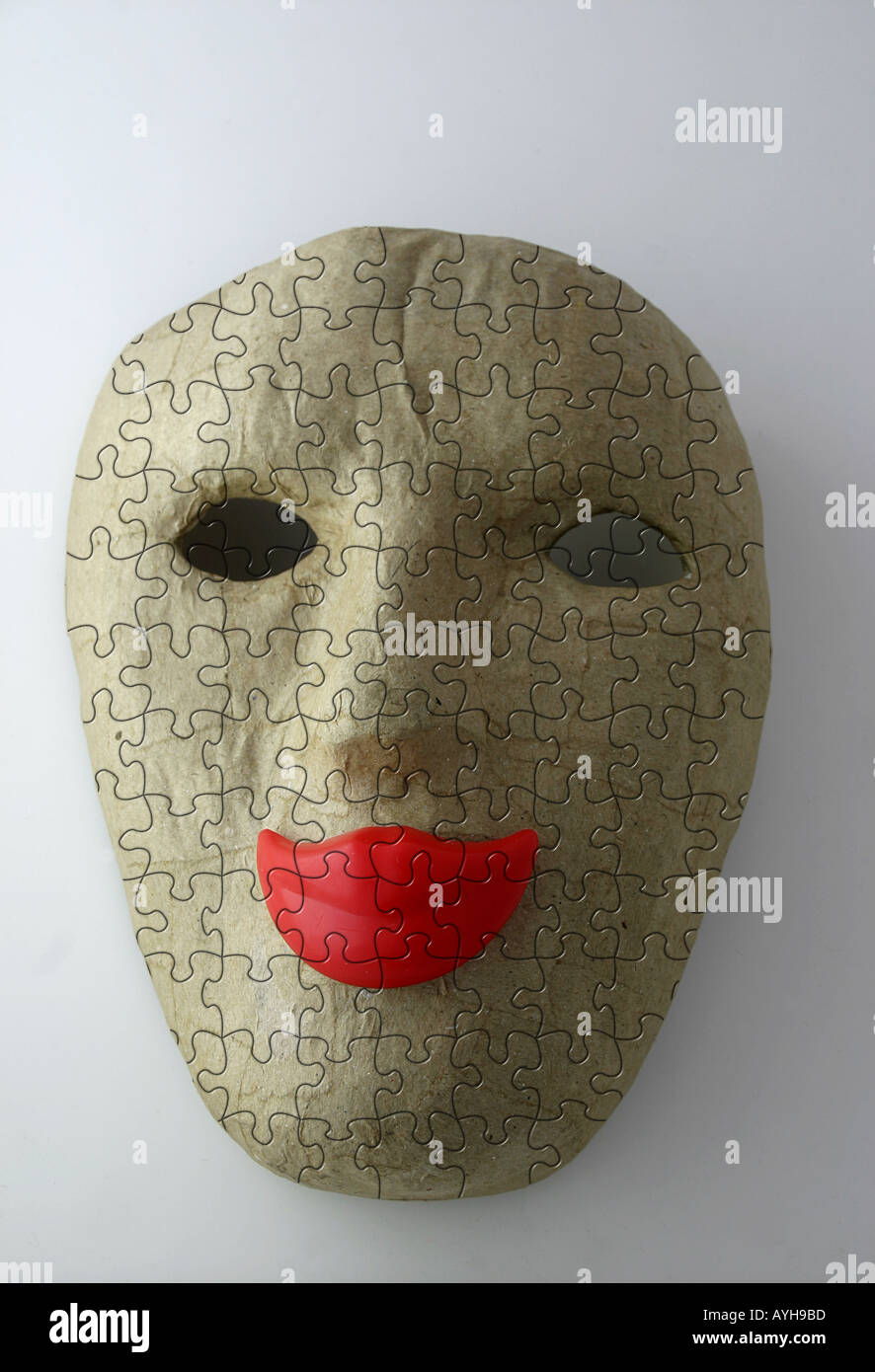 Puzzled face mask with smiling red lips Stock Photo
