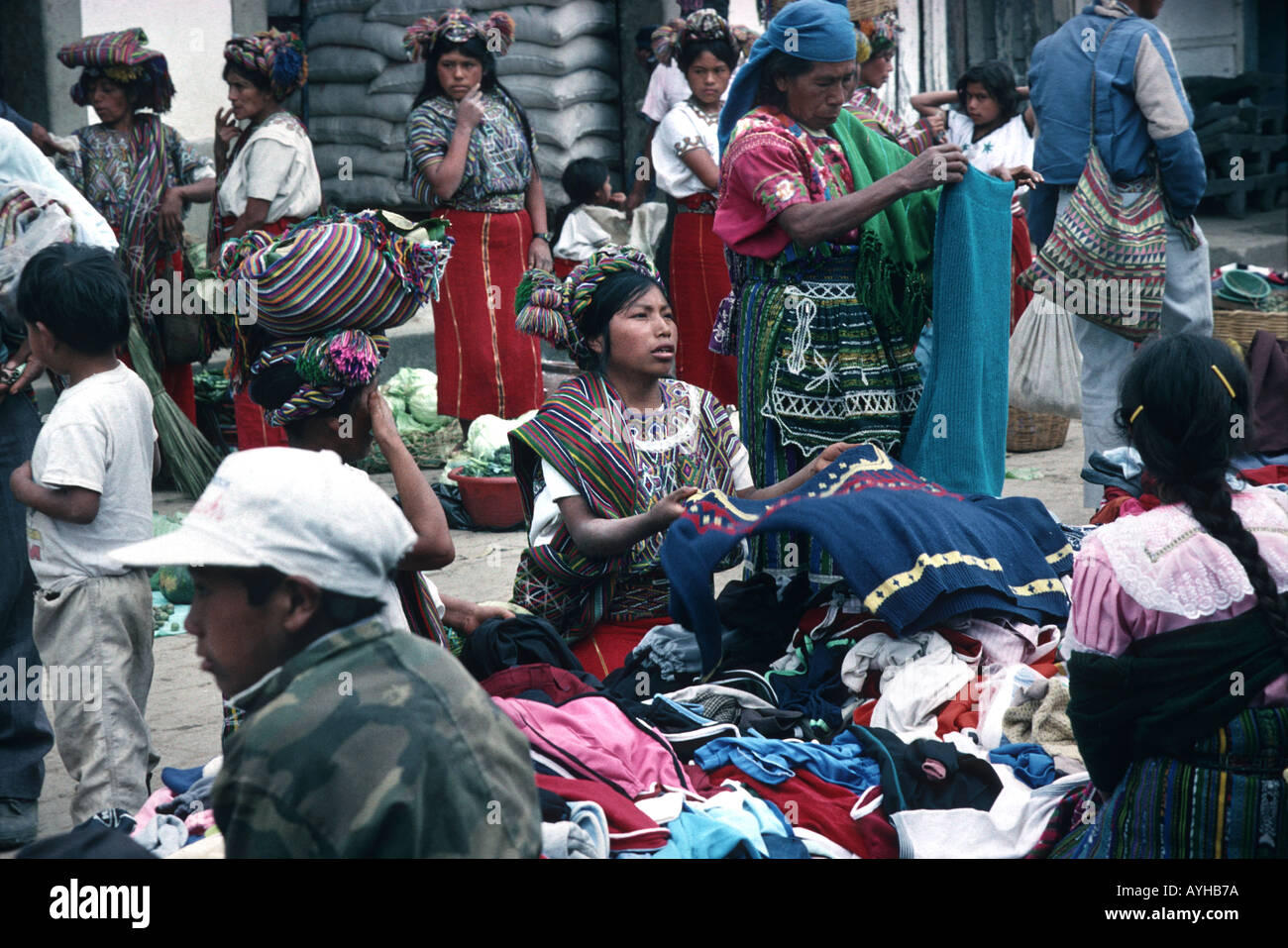 Woman from Nebaj at market haggling over the price of some used clothing Ixil Triangle El Quuiche Guatemala Central America Stock Photo