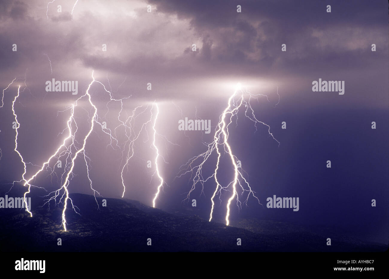 Multiple cloud to ground lightning bolts during summer monsoon storm on the Rincon Mountains in Tucson, Arizona, United States. Stock Photo