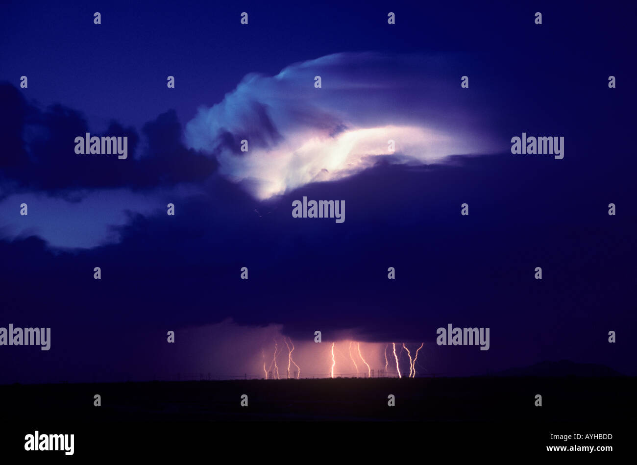 Distant cloud to ground lightning during summer monsoon storm in Southwestern Arizona United States Stock Photo