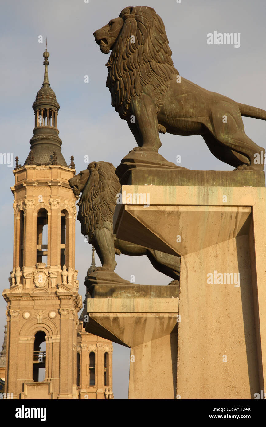 Lion Entrance to Puente de Piedra Bridge with the Basilica de Nuestra Senora del Pilar in the background, Zaragoza, Spain Stock Photo