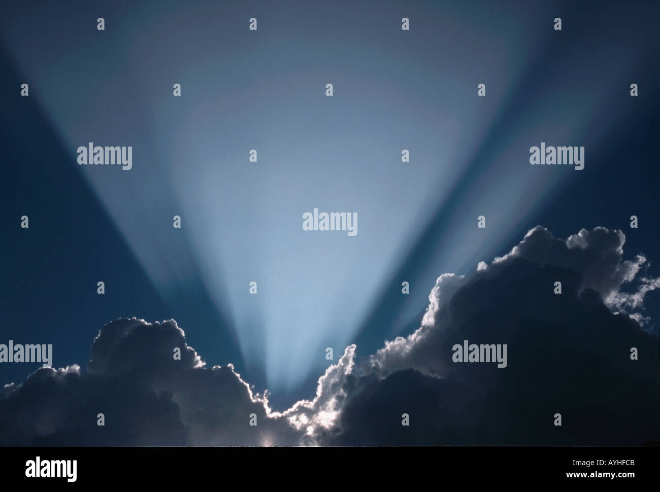 Sun rays behind dark clouds Stock Photo - Alamy