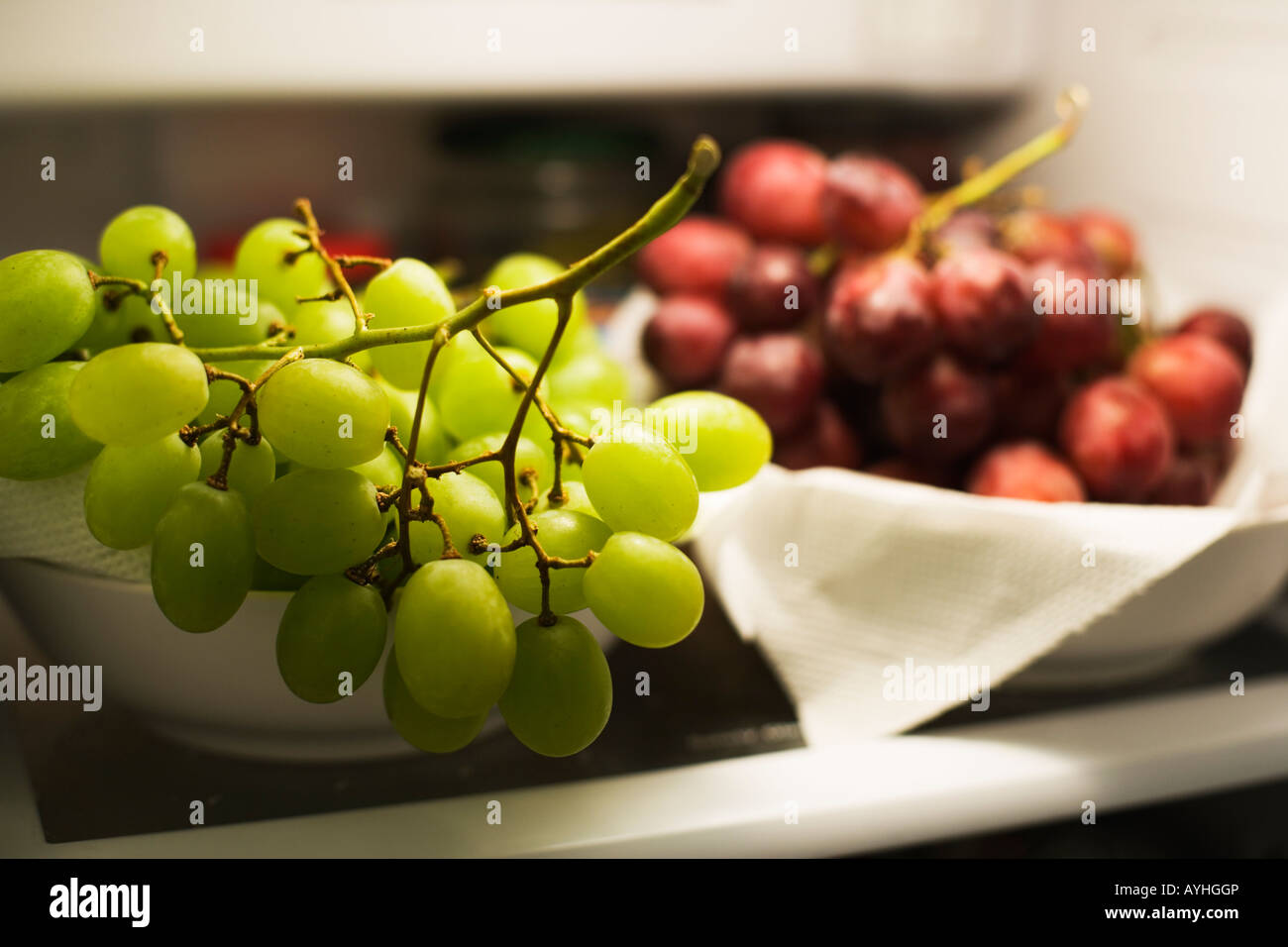Green and red grapes on a shelf in refrigerator Stock Photo - Alamy