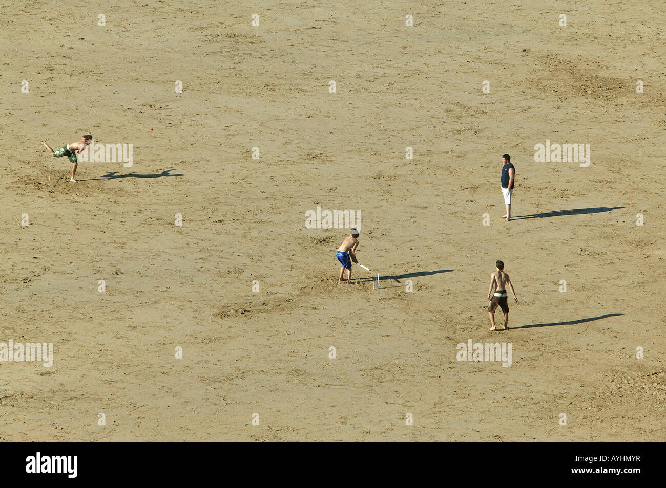 Young Men playing a game of Beach Cricket Stock Photo