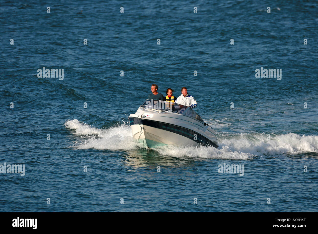 People enjoying a ride on a motor boat Stock Photo - Alamy