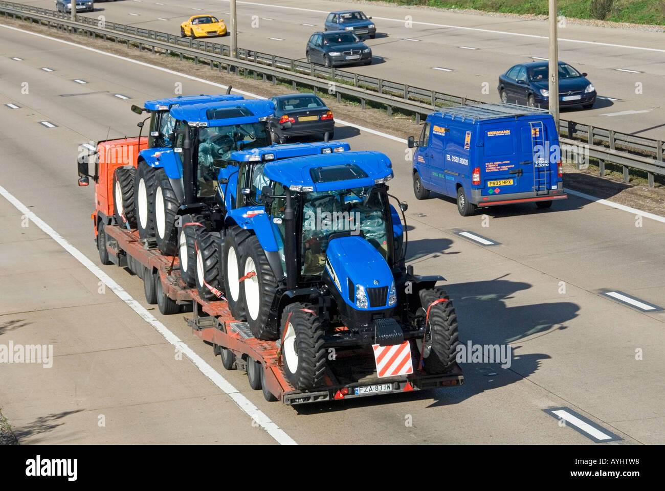 M25 motorway low loader lorry carrying new tractors Stock Photo Alamy