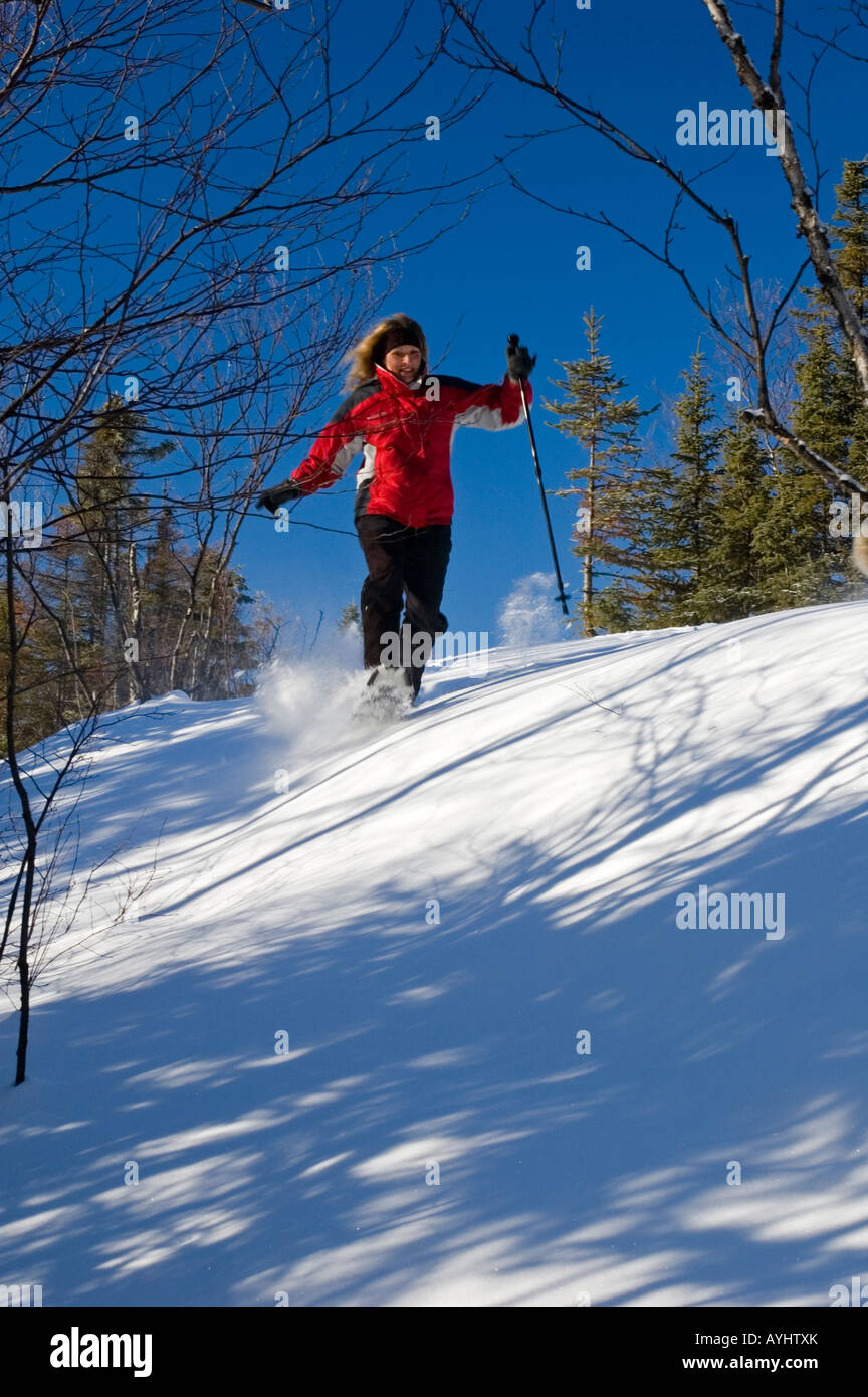 WOMAN SNOWSHOEING IN NORTHERN ONTARIO Stock Photo