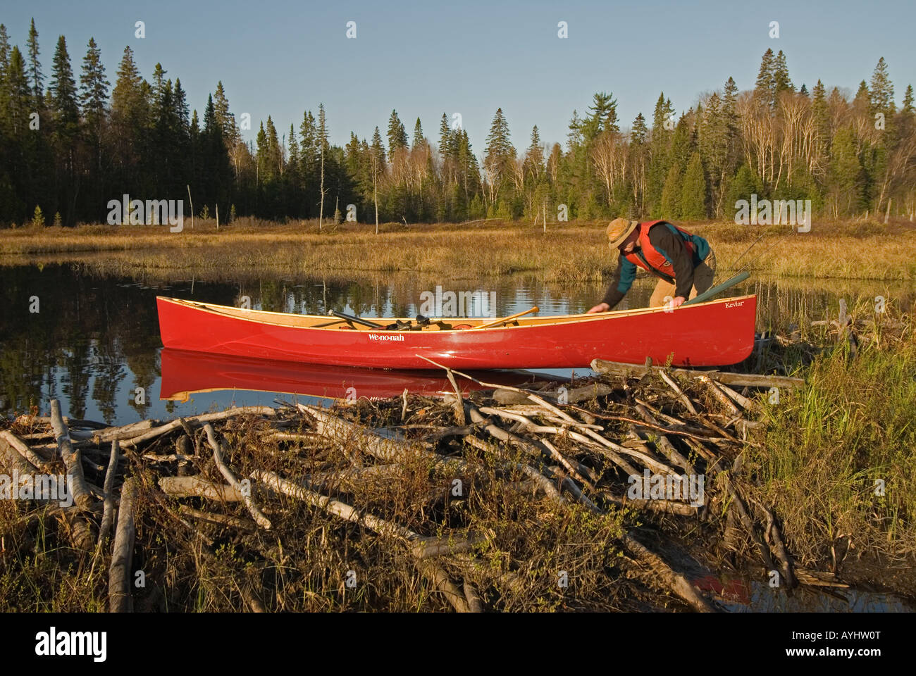 pushing canoe from beaver dam Stock Photo