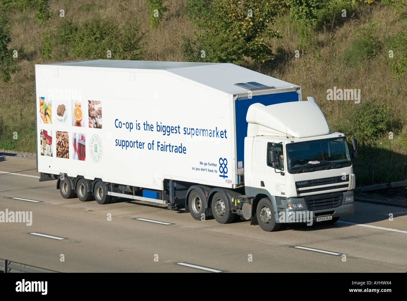 Fairtrade fair trade Co Op supermarket advertising on articulated trailer behind Daf hgv store delivery lorry truck driving along motorway England UK Stock Photo