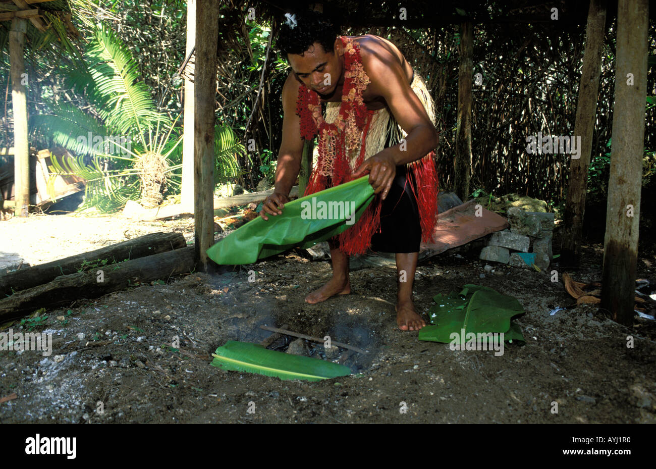 Tonga Preparing a traditional Umu an underground oven to cook food
