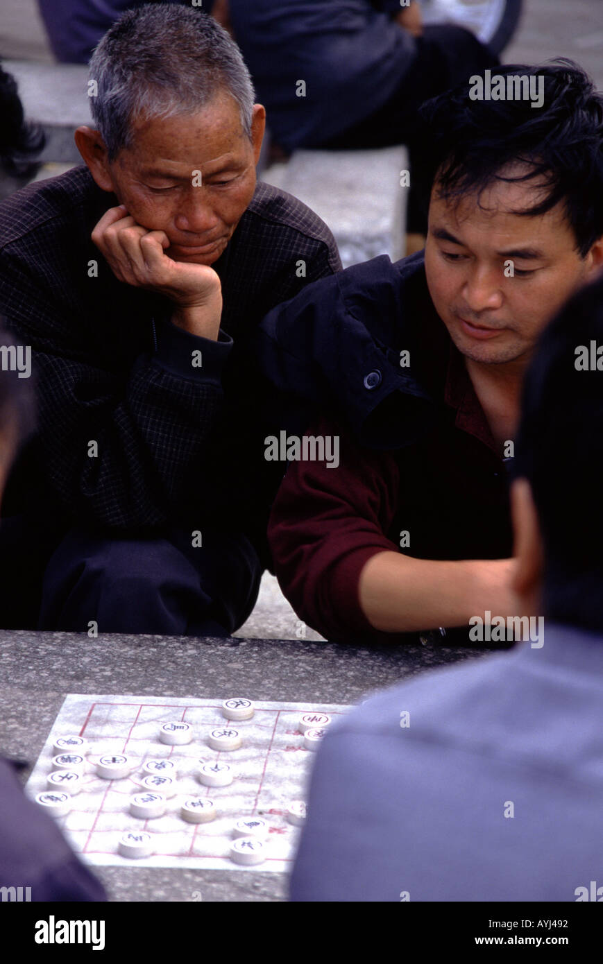 Local men playing Chinese Chess in Dali Yunnan province China Stock Photo